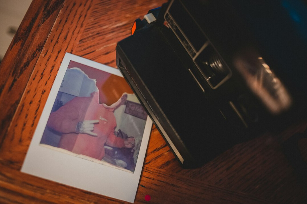 Documentary photographer reviewing printed photos at a desk