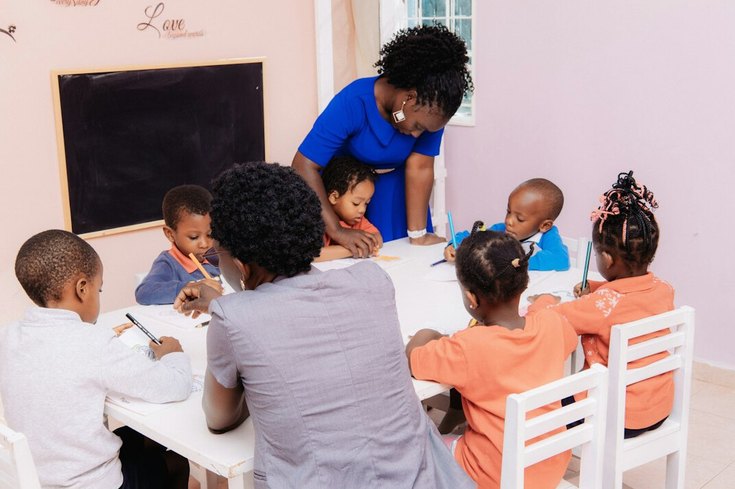 woman teaching children