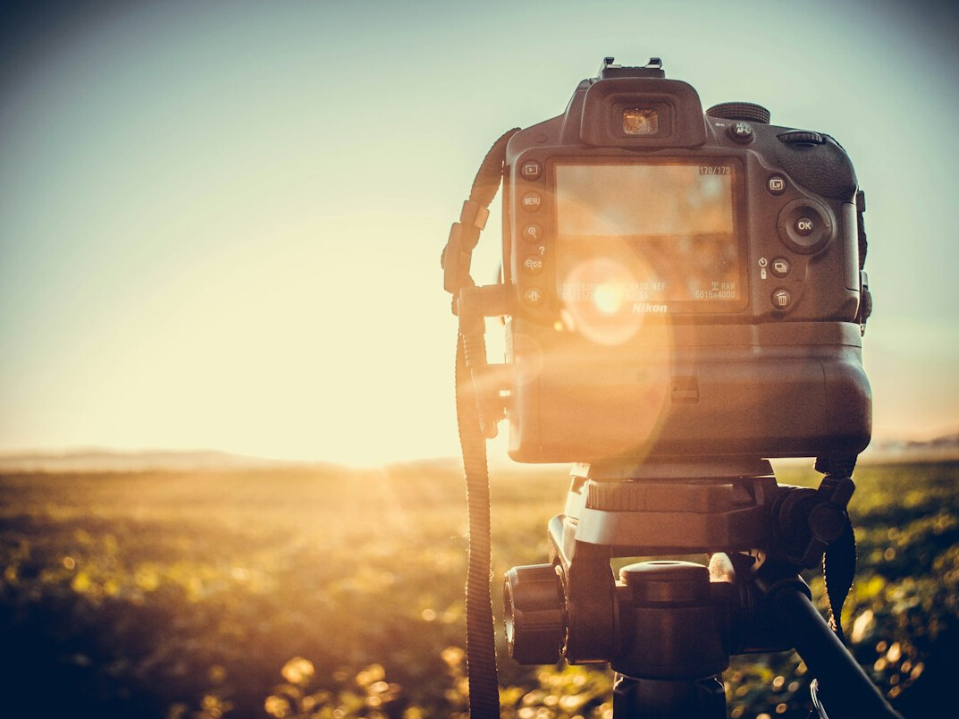 photographer with camera in field