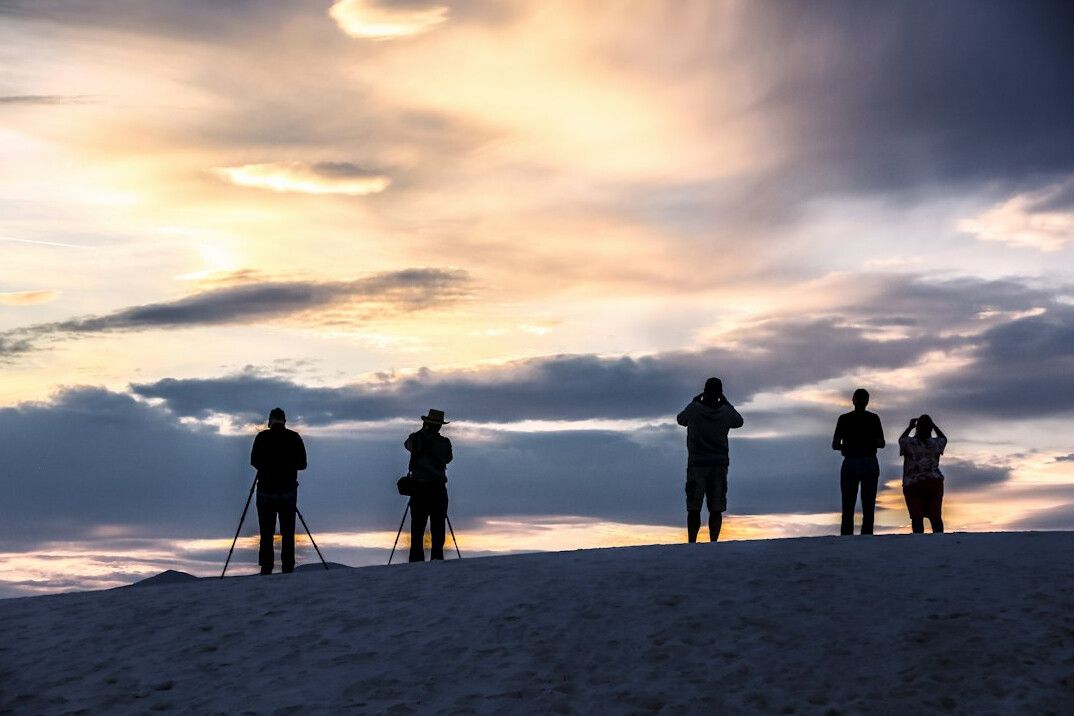 Small team of photographers and journalists standing together